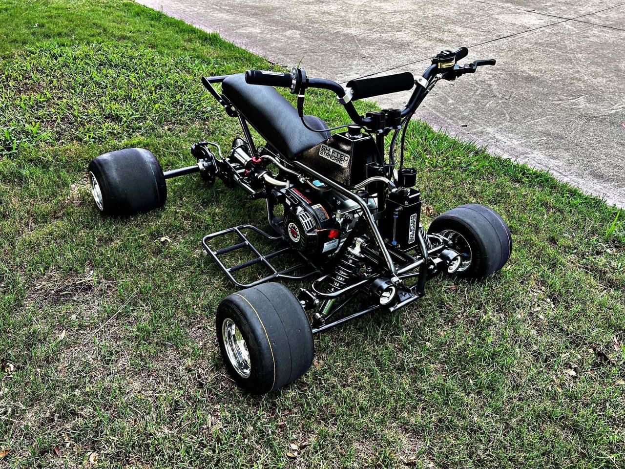 The Blackout Mini Quad featuring 304 Stainless Steel Mid Pipes and Red Powder Coated End Tips