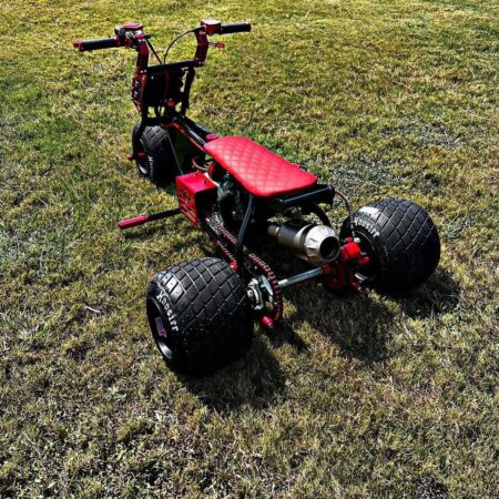 Astatic Red Mini Trike showcasing its powerful 212cc engine and custom design.