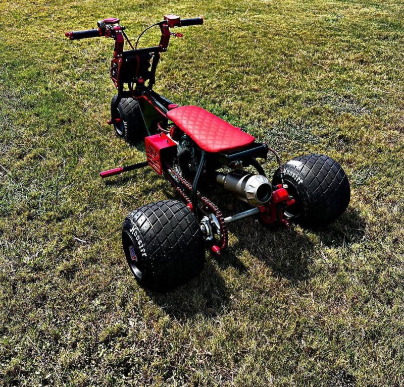 Astatic Red Mini Trike showcasing its powerful 212cc engine and custom design.